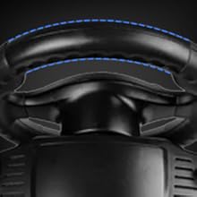 Close-up of a black gaming chair headrest with blue accent stitching. Visible cushioning and leather-like material texture on the surface.