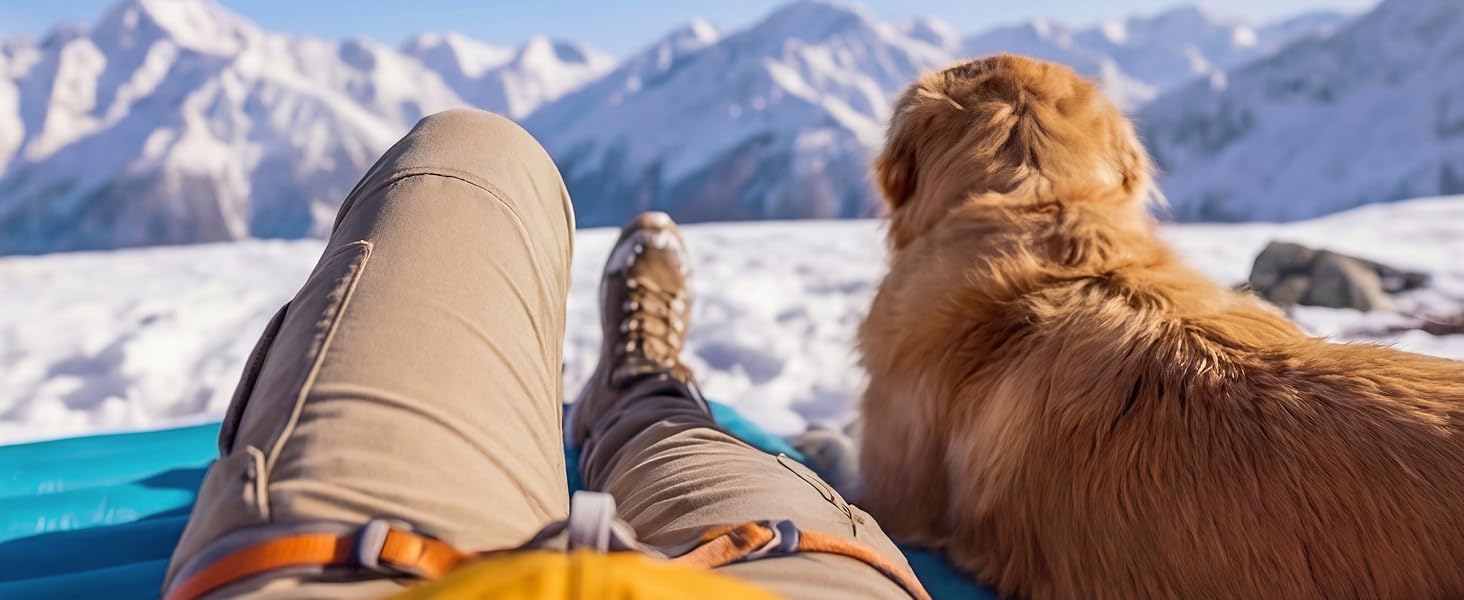 POV relaxing on Airlive2000 pad with dog, snowy peaks ahead.