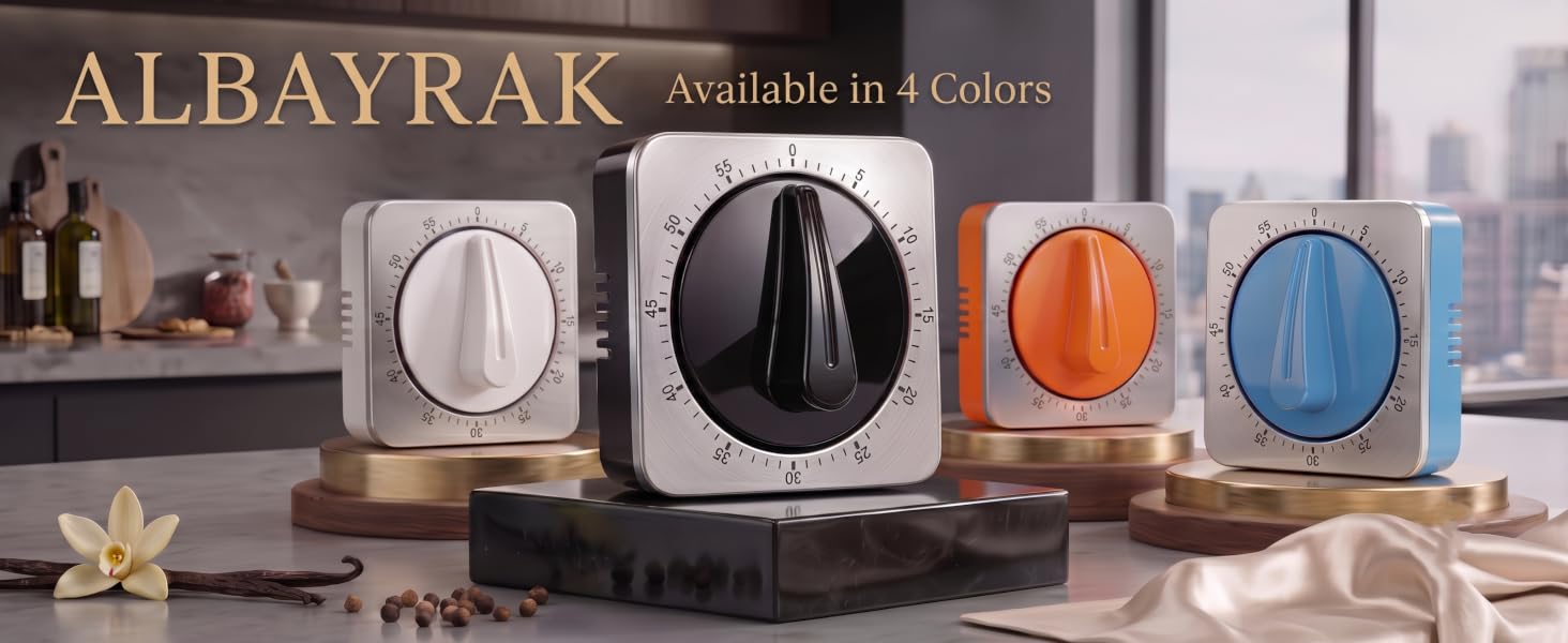 Four Albayrak mechanical timers (black, white, orange, blue) on elegant pedestals in a kitchen.