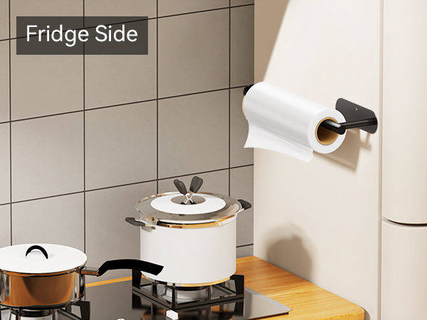 Self adhesive black paper towel holder mounted on refrigerator beside stove for kitchen use