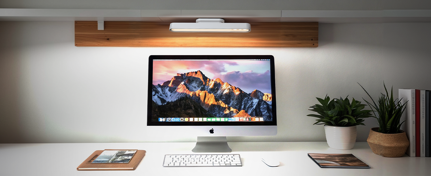 a computer monitor with a mountain scene on it.