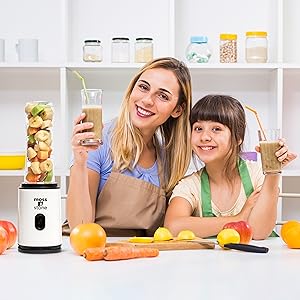Family preparing smoothies together using a single serve smoothie maker