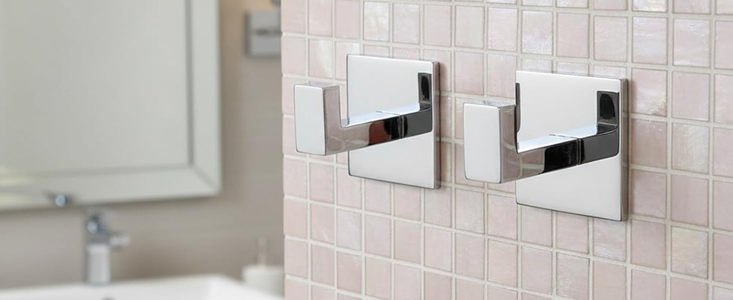 Multiple views of modern bathroom wall-mounted accessories in chrome finish against pink tile backdrop, showing installation progression.