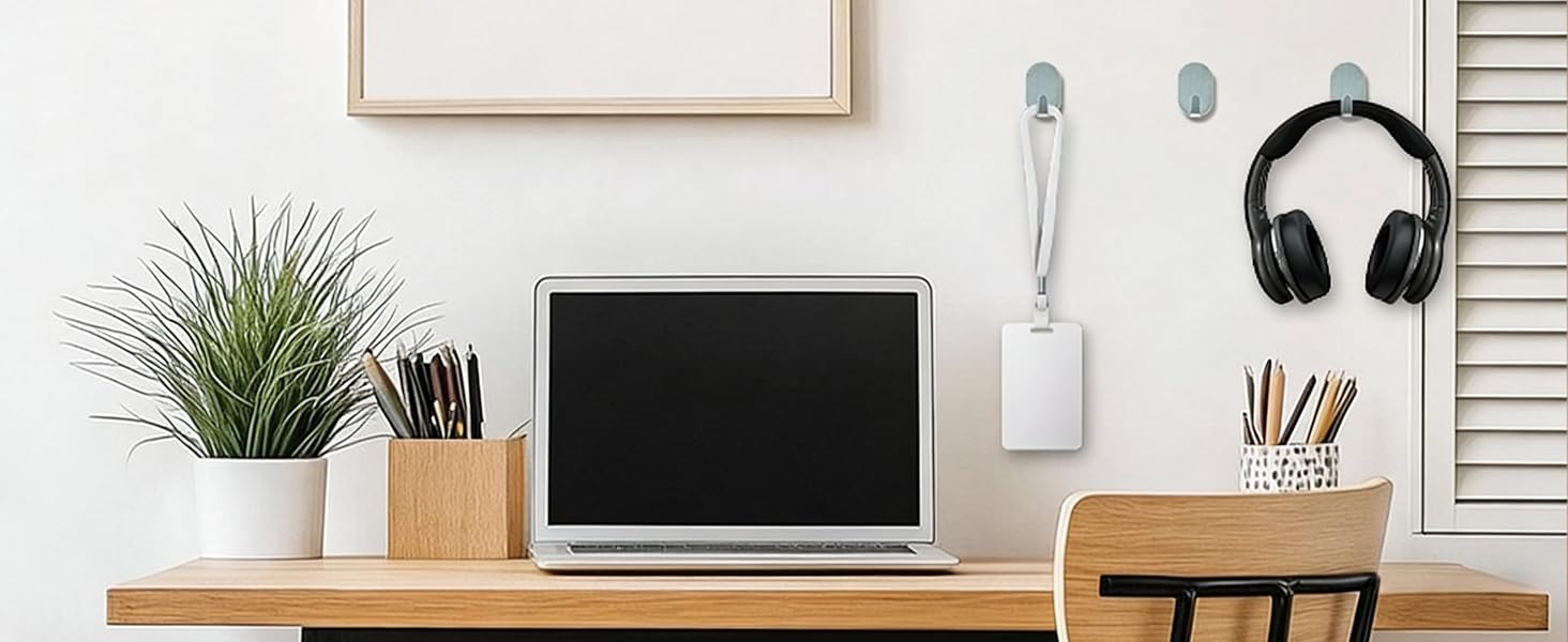 Modern home office workspace with wooden desk, monitor, keyboard, desk plant, and white slatted wall. Clean minimalist setup with natural lighting.