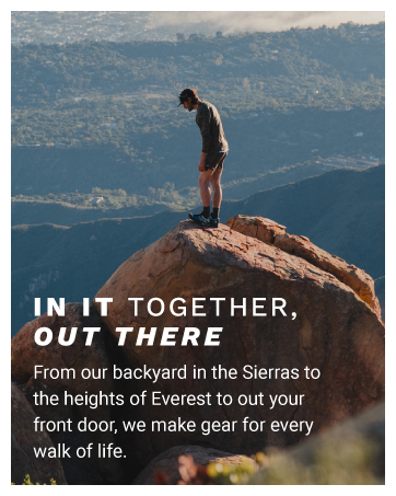 Marmot man climbs large rock with clouds and forest in background