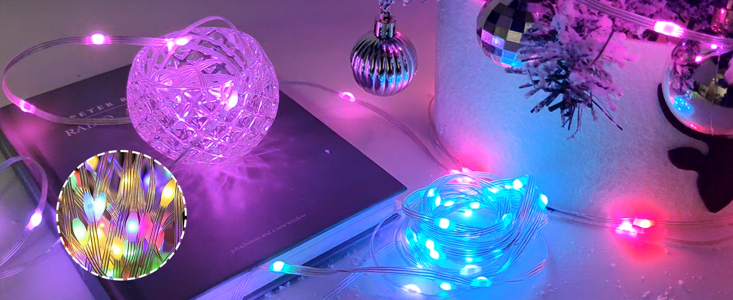 Decorative LED light display with purple glass orbs and string lights creating an ambient purple and blue glow against a dark background.