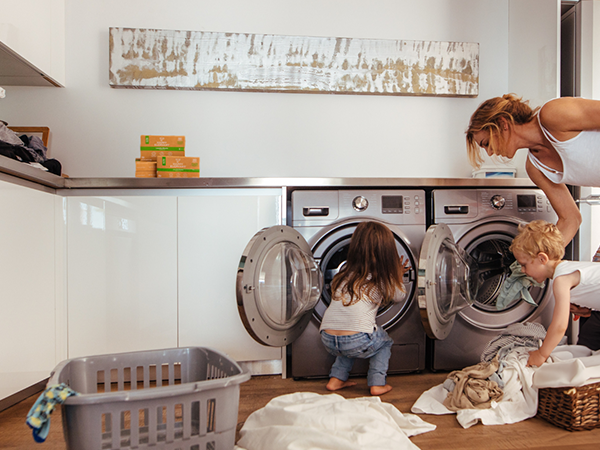 mom and children helping with laundry