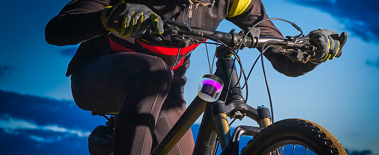 a person wearing a black jacket and gloves holding a bike handlebar.
