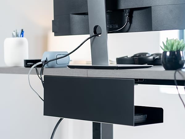 Sits just below the desktop to conceal cables while maintaining easy access when needed