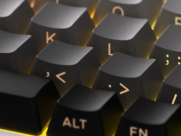 Black mechanical keyboard with golden/yellow accents on keys and keycaps. Keys visible include 'K', 'L', '<', '>', 'ALT', 'FN'. Close-up shows angled key design with metallic highlighting.