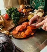 hands chopping carrots on countertop