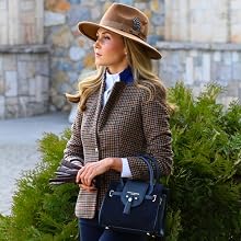Fashion photography series showing brown plaid blazer and navy handbag against stone wall backdrop with greenery. Wide-brimmed hat completes the autumn outfit styling.