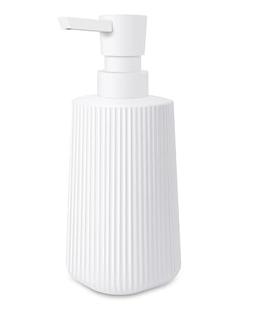 White ribbed ceramic soap or lotion dispenser bottle with pump top on white background.