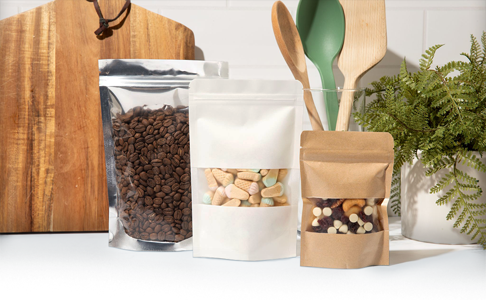 A kraft, white, and aluminum mylar stand-up pouch in front of a white kitchen background