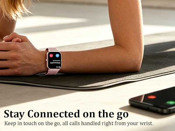 Text reads 'Stay Connected on the go' and 'Keep in touch on the go, all calls handled right from your wrist.' Wrist smartwatch displayed on person's arm near laptop and smartphone on desk.