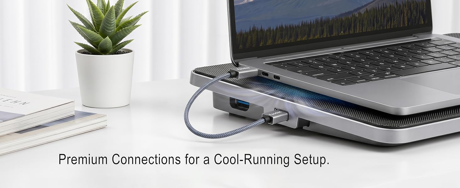 USB-A cable powering a laptop cooling pad in a clean desk setup.