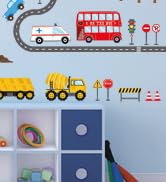 Cartoon-style wall decals featuring vehicles including a red double-decker bus, yellow construction vehicles, and traffic signs in blue and red colors.