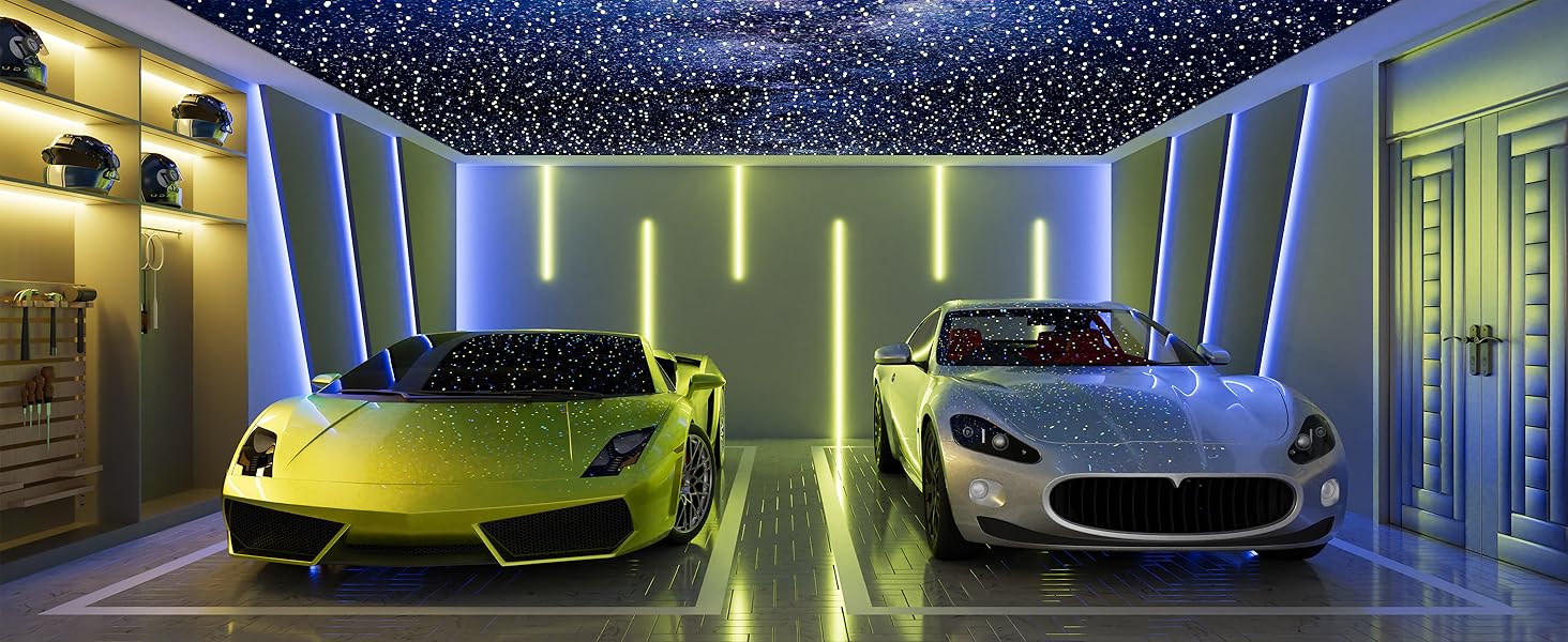 Two luxury sports cars in a modern garage with starry ceiling. Yellow car on left, silver car on right. Illuminated walls with vertical light strips create futuristic ambiance.