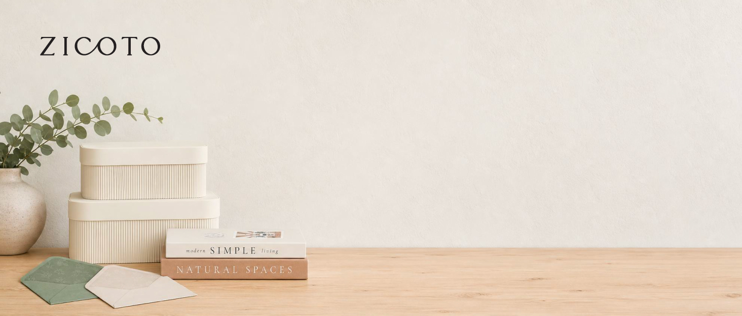 ZICOTO brand scene with storage boxes, books, envelopes and a botanical on a wooden table.