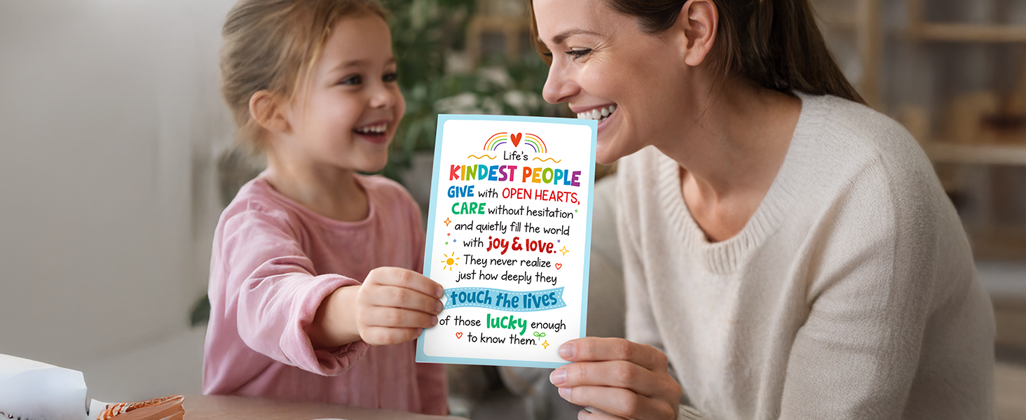 A photo of a girl giving a school counselor appreciation card to her teacher.
