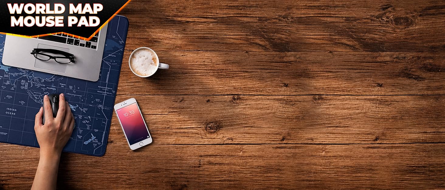 World map mouse pad on wooden desk with laptop, coffee, and phone