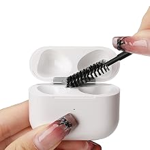 Small brush removing dust from the inside of an AirPods charging case