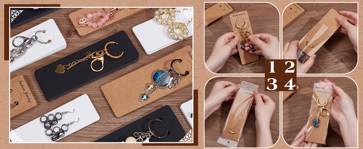 Assortment of jewelry display cards and accessories on wooden surface. Cards hold earrings, necklaces, and keychains. Hands demonstrate packaging items in kraft paper envelopes with number labels.