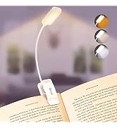 Flexible USB book light with three brightness settings shown clipped to a book page. White LED light on gooseneck arm with clip-on base.