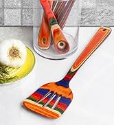 colorful wooden slotted spatula in kitchen