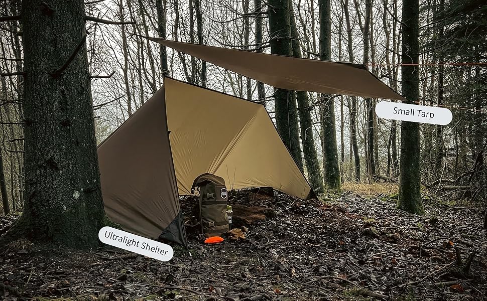 Outdoor tarp shelter setup in forest. Brown tarp angled between trees, with campfire visible underneath. Labels indicate 'tarp' and 'ridge line'.