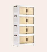Vertical stack of four small rectangular white storage boxes or organizers with gold-colored drawer fronts or labels.