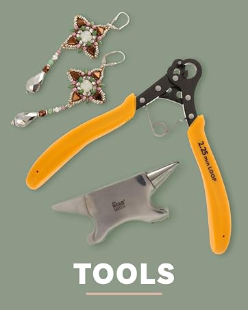 Jewelry crafting tools, including a small anvil and pliers, on a light blue background with