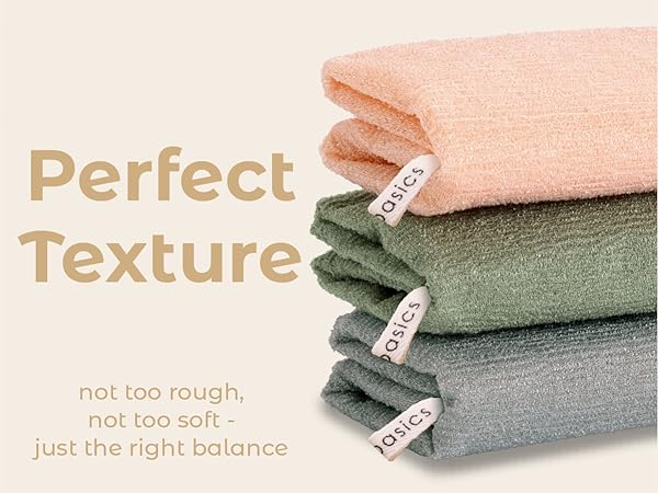 Soft yet textured body scrub towel stack for effective cleansing.