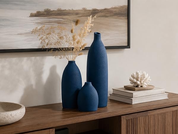 Three textured navy blue ceramic vases styled as elegant mantel decor