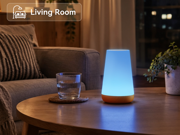 Color changing portable night light lamp glowing blue on coffee table in cozy living room