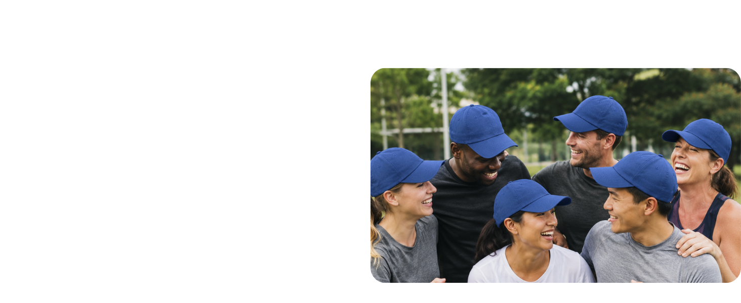 group of people all wearing matching plain navy dad hats outdoors in a park or sports field.