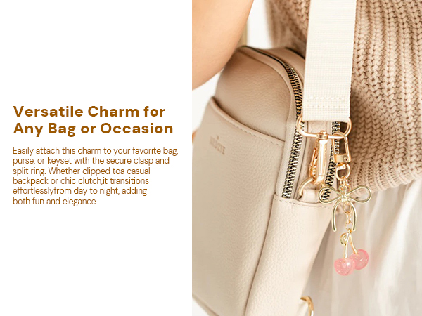 Pink Cherry Charm with Gold Clasp Hanging on Beige Handbag Strap