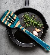 colorful wooden slotted spatula over skillet