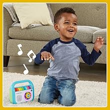 Kid smiles while listening along with music player.