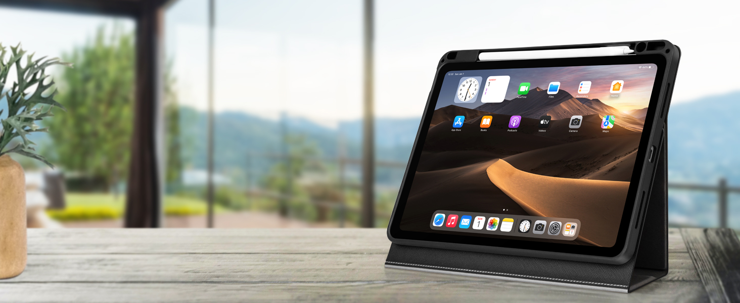 Tablet device in a protective case, displaying an app interface. The tablet is positioned on a wooden surface with a blurred outdoor background.