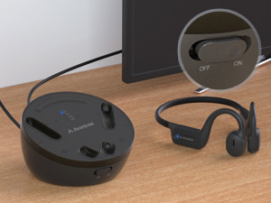Power on the headphones and the transmitter/charging stand.