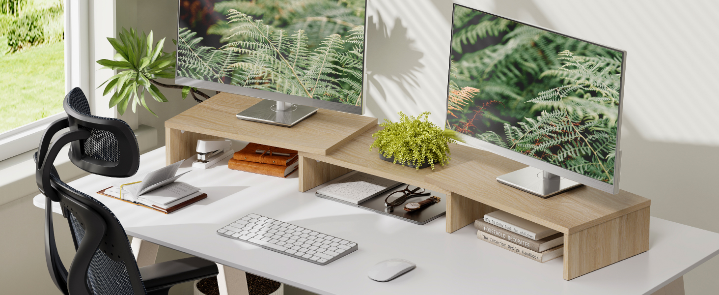 Modern home office workspace featuring a wide desk with wooden shelving, multiple monitors, keyboard, mouse, office chair, and decorative plants in the background.