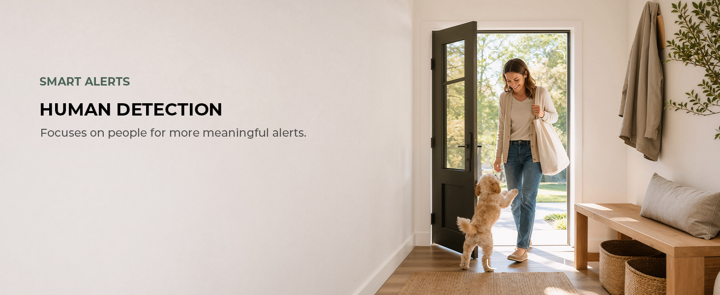 Dog at the front door as a person enters, illustrating human motion detection.