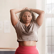 Woman with hands behind her head