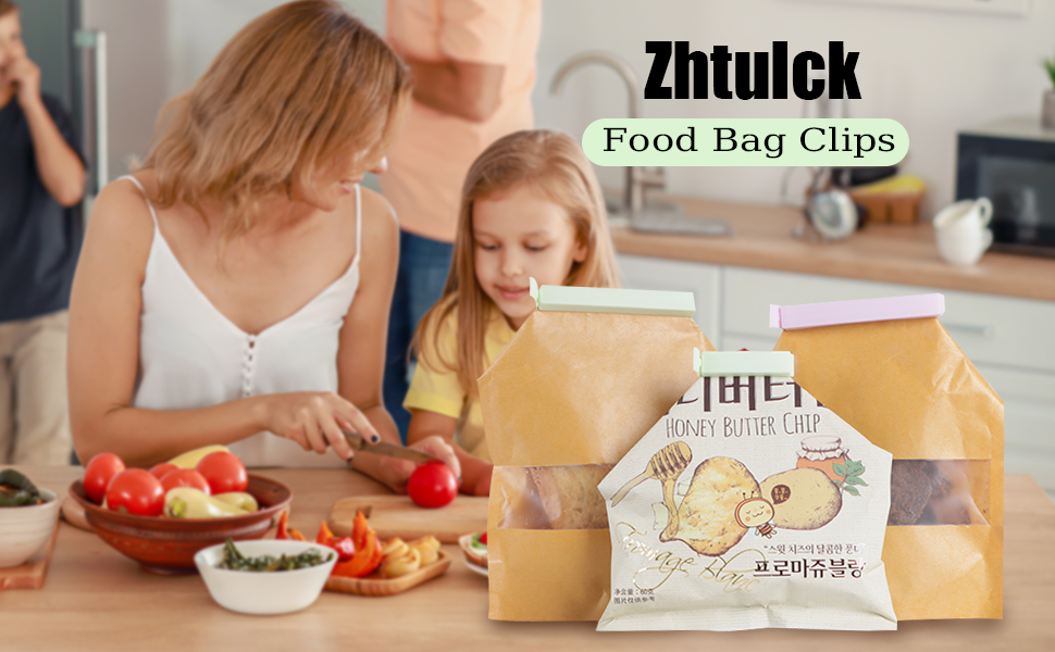 Zhtulck Food Bag Clips displayed on table. Woman and child preparing food in background with fruits and snacks visible.