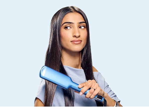 Woman straightening hair