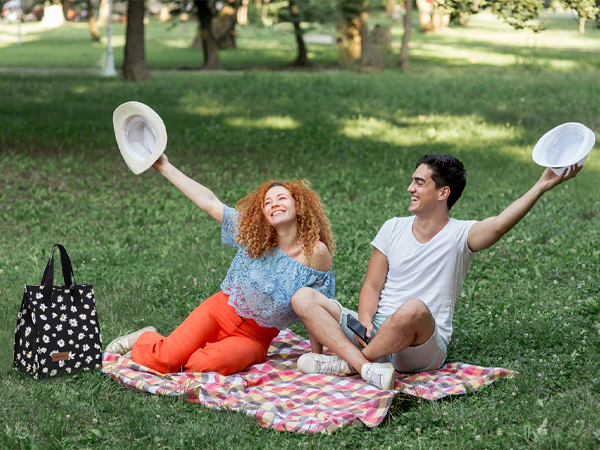 Series of outdoor picnic scenes on red and white checkered blanket laid on grass, showing people relaxing and enjoying food outdoors.