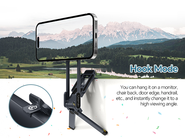Text reads 'Black Magic'. Product photo of black smartphone stabilizer mount with mountain landscape backdrop. Device features adjustable grip and phone holder mechanism.