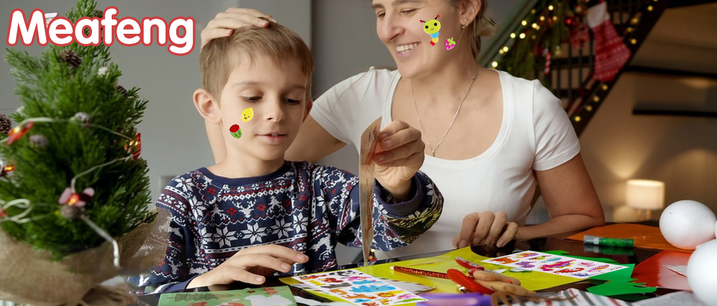 Colorful craft or activity materials spread on table with decorated Christmas tree visible in background.
