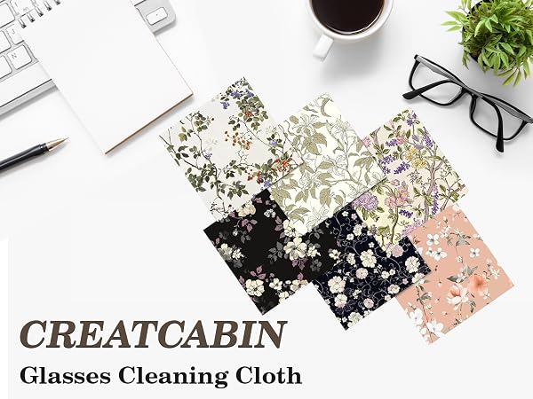 Text reads 'CREATCABIN' and 'Glasses Cleaning Cloth'. Flatlay of office supplies including glasses, cleaning cloth with floral pattern, notebook, and plant.